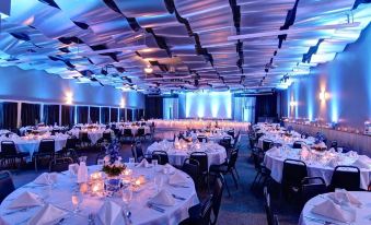 a large banquet hall with tables and chairs set up for a formal event , possibly a wedding reception at Metropolis Resort - Eau Claire