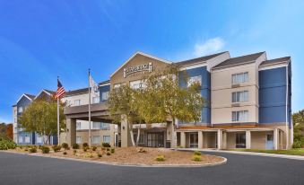 a holiday inn express hotel with an american flag flying in front of it at Staybridge Suites Pittsburgh Airport