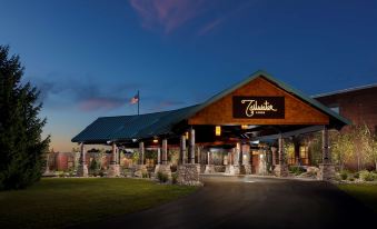 "a large building with a sign that reads "" el calafate "" on the front , surrounded by grass and trees" at Tailwater Lodge Altmar, Tapestry Collection by Hilton