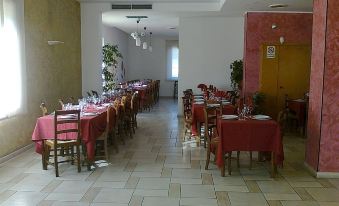 a dining room with several tables and chairs arranged for a group of people to enjoy a meal together at Hotel Millennium