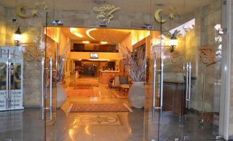 the entrance to a hotel lobby with a glass door and a chandelier above it at Platinum Hotel