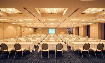 a large conference room filled with rows of chairs and tables , ready for a meeting or event at Hotel Resol Gifu