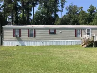 Near the water  and close to a  boat ramp