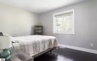 Torch Lake 4 bedroom home w/ large yard & parking