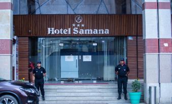 two security guards standing outside a hotel entrance , ready to protect customers and the security of the building at Hotel Samana