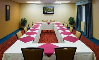 a conference room with a long table covered in white and pink checkered tablecloths , surrounded by chairs at Residence Inn Provo North