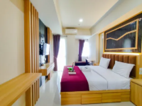 Wood Accents Studio at Grand Dharmahusada Lagoon Apartment by Travelio