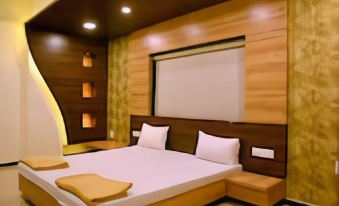 a modern bedroom with wooden walls , a large bed , and a tv mounted on the wall at Angel Hotels