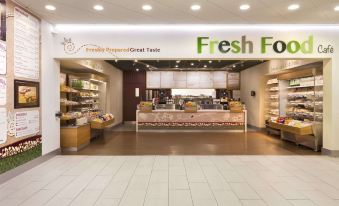 "a modern grocery store with a large display of fresh food and a green sign that says "" fresh food .""." at Days Inn by Wyndham Taunton