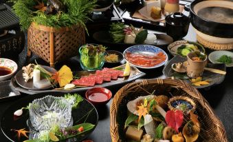 a dining table filled with a variety of food items , including fruits , vegetables , and desserts at Miyako