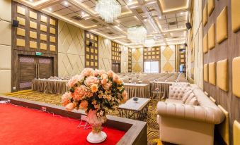 a large , well - lit room with a red carpet and a floral arrangement in the center at Gallery Design