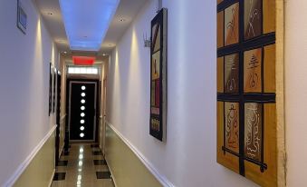 At one end, there is a long hallway with lights on the walls and tiled floors at Millennium Apartments
