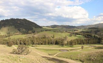 a scenic view of a green valley with winding roads and rolling hills in the distance at Hampton Halfway Hotel Motel