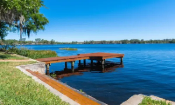 Lakeside Retreat~ Large home with pool, dock, game room and balcony on lakefront