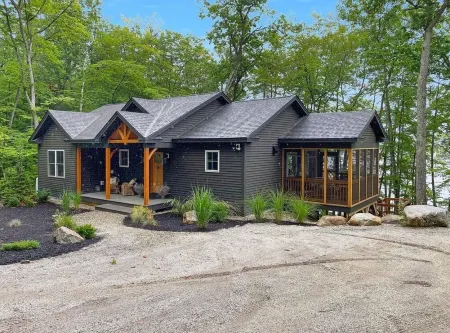 Beautiful new modern cabin with 100 feet of shoreline on Long Lake