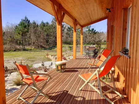 Three wooden houses with terraces near the ocean