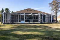 Enjoy this waterfront home with a pool, dock, and Blue Angels! Bring your boat!