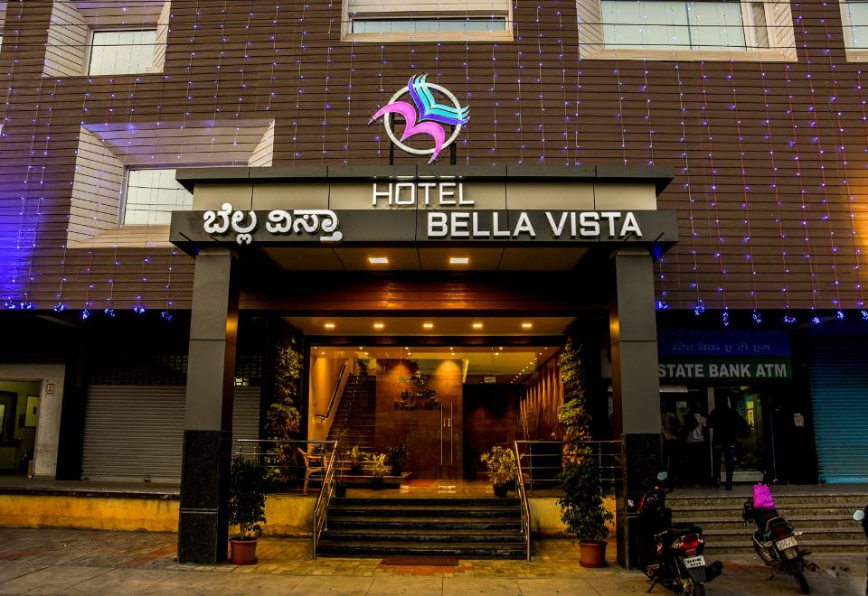 "a hotel entrance with a sign that reads "" hotel bella vista "" and a motorcycle parked in front" at Hotel Bella Vista