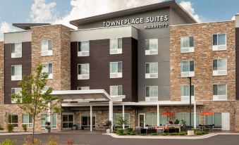"a large hotel building with multiple floors , surrounded by trees and a parking lot , under the brand name "" towneplace suites by marriott ""." at TownePlace Suites Milwaukee Grafton