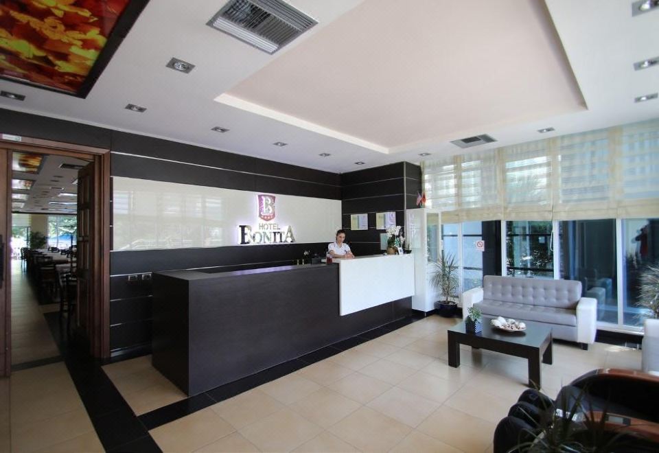 The hotel lobby features an open concept design, integrating the front desk and reception area at Hotel Bonita