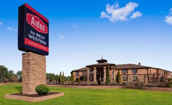 an exterior view of a large hotel building , possibly a hotel , surrounded by grass and trees at Aiden by Best Western @ Warm Springs Hotel and Event Center