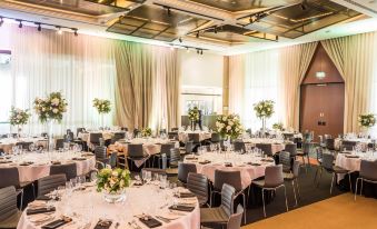 a large banquet hall with numerous tables and chairs set up for a formal event at Hyatt Place Melbourne Essendon Fields