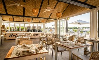 an outdoor dining area at a restaurant , with tables and chairs arranged for guests to enjoy their meal at Lago Resort Menorca Casas del Lago