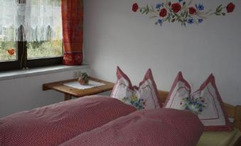 a hotel room with a king - sized bed , two lamps , and framed pictures on the wall at Casa Mia