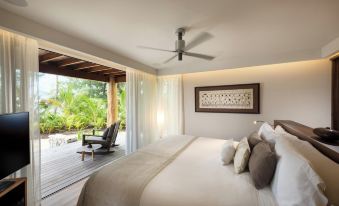 a bedroom with a large bed and sliding glass doors leading to an outdoor patio at The Brando