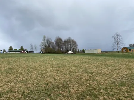 King bed in Tulip Glamping Aframe at Noble Pine Campground