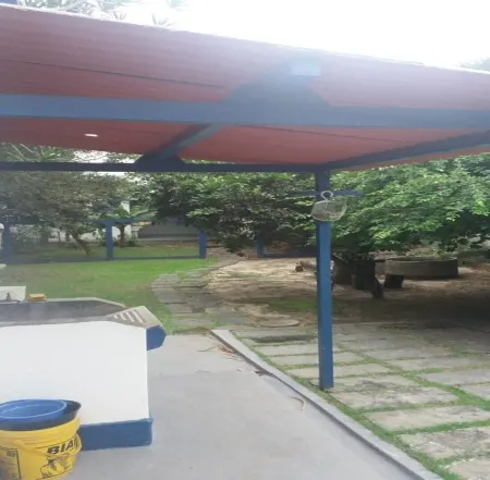 home Beach Center, wooded and grassy yard with fruit trees.