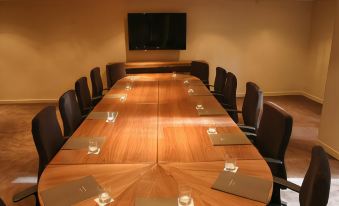 a large conference room with a long wooden table and multiple chairs arranged for a meeting at Isle of Mull Hotel and Spa