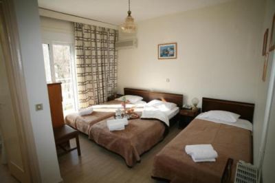 a hotel room with two beds , one on the left side of the room and the other on the right side at Hotel Summery