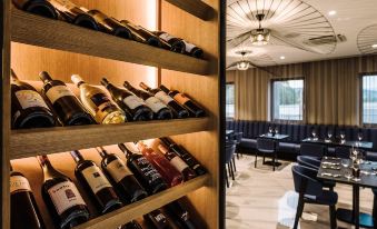 a wooden wine rack with bottles of wine is in a room with chairs and tables at Hotel A