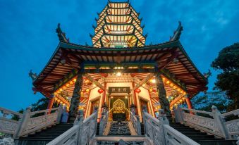 a large , ornate chinese temple with a red roof and a white gate at the entrance at Griya Ayem