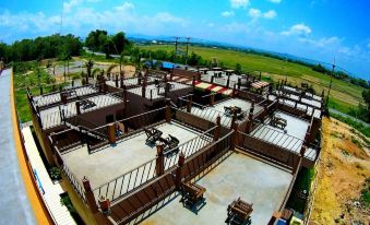 a large , open area with multiple fences and tables on the ground , surrounded by a vast landscape at Rapeepong Resort Nanthai