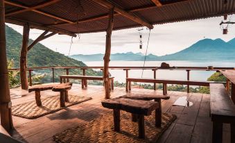 a wooden deck overlooking a body of water , with several benches placed around the area at Eagle's Retreats