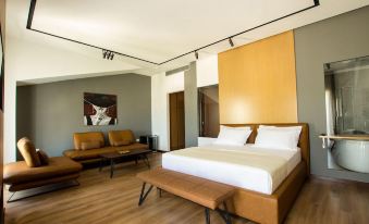 a modern bedroom with a large bed , wooden furniture , and a painting on the wall at Hotel Fantasy