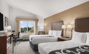 a hotel room with two beds , one on the left and one on the right side of the room at The Inn at GIG Harbor