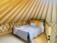 Elevated eclectic yurt with wrap-around porch, hot tub, and mountain view!