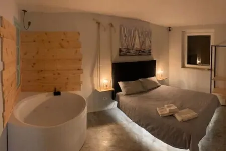 Lake view apartment with large hydromassage tub directly in the bedroom.