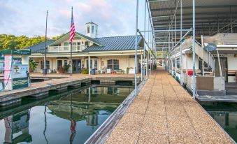 a building with a flag flying and a bridge over water , reflecting the american flag at Dale Hollow Lake State Resort Park