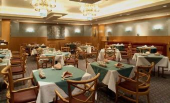 a large dining room with multiple tables and chairs arranged for a group of people to enjoy a meal together at Keio Plaza Hotel Hachioji