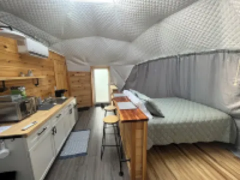 Cozy lakeside glamping dome with fireplace, AC and full bath.