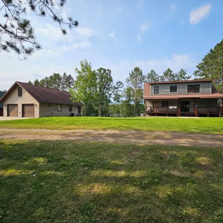Three bedroom hide-a-way with spacious deck over looking Island Lake.