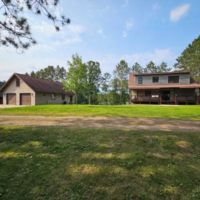 Three bedroom hide-a-way with spacious deck over looking Island Lake.