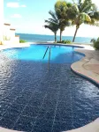 Quiet and serene ocean front 2-bedroom 2-bathroom condo, steps from the sand!