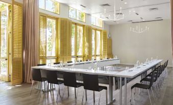 a large conference room with a long table and multiple chairs arranged for a meeting at Hotel Healdsburg