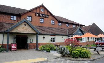 the beefeater hotel in whitby , uk , with its name displayed on a brick building and surrounded by flowers at York North West