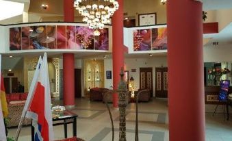 The second floor of the lobby features two large chandeliers and various decorative items at Desert Sounds - Boutique Hotel